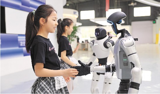 6月19日,东营融瓴机器人联盟科技探索基地,孩子们与机器人握手互动,感受智能科技魅力。(周广学 报道)